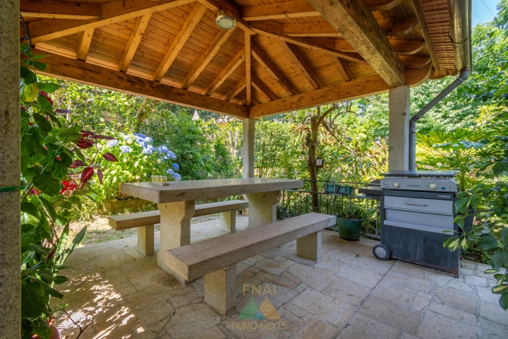 Covered stone BBQ gazebo with gas grill