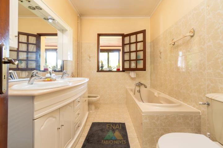 Main bathroom with double vanity and bathtub
