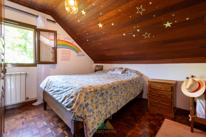 Attic bedroom with timber ceiling and glow stars